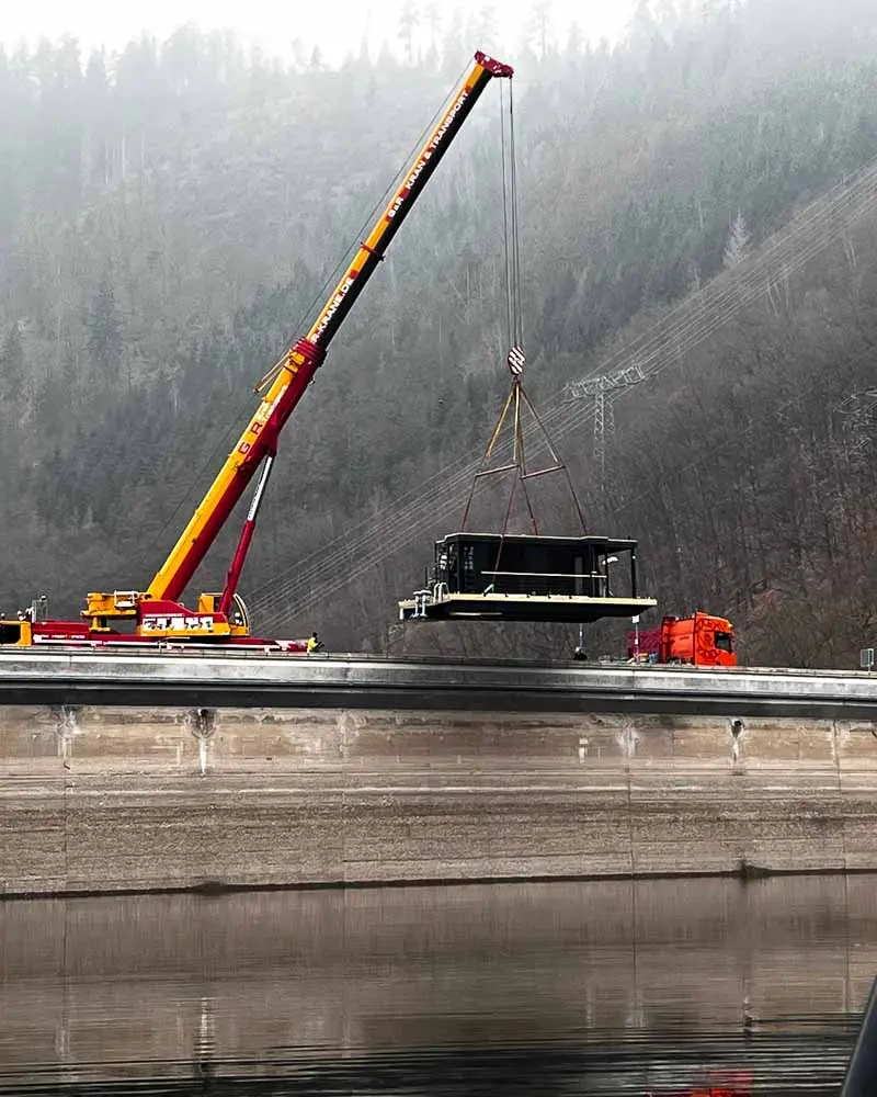 The SaaleSpa sauna boat is carefully inserted into the water